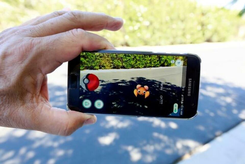 The augmented reality mobile game "Pokemon Go" by Nintendo is shown on a smartphone screen in this photo illustration.  (Reuters Photo/Sam Mircovich/Illustration)