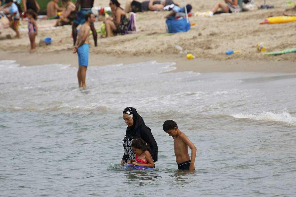 A Muslim woman wears a burkini, a swimsuit that leaves only the face, hands and feet exposed, on a beach in Marseille, France, August 17, 2016.   (Reuters Photo/Stringer)    