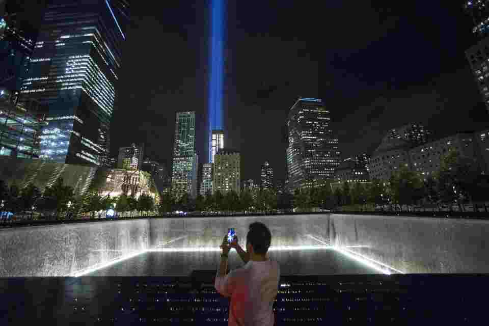 A man takes a photo at the 9/11 Memorial and Museum near the Tribute in Light in Lower Manhattan, New York. (Reuters Photo/Andrew Kelly)