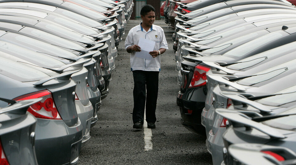 A worker checks new Proton cars at a yard near Kuala Lumpur in this January 2009 file photo. (Reuters Photo/Zainal Abd Halim)