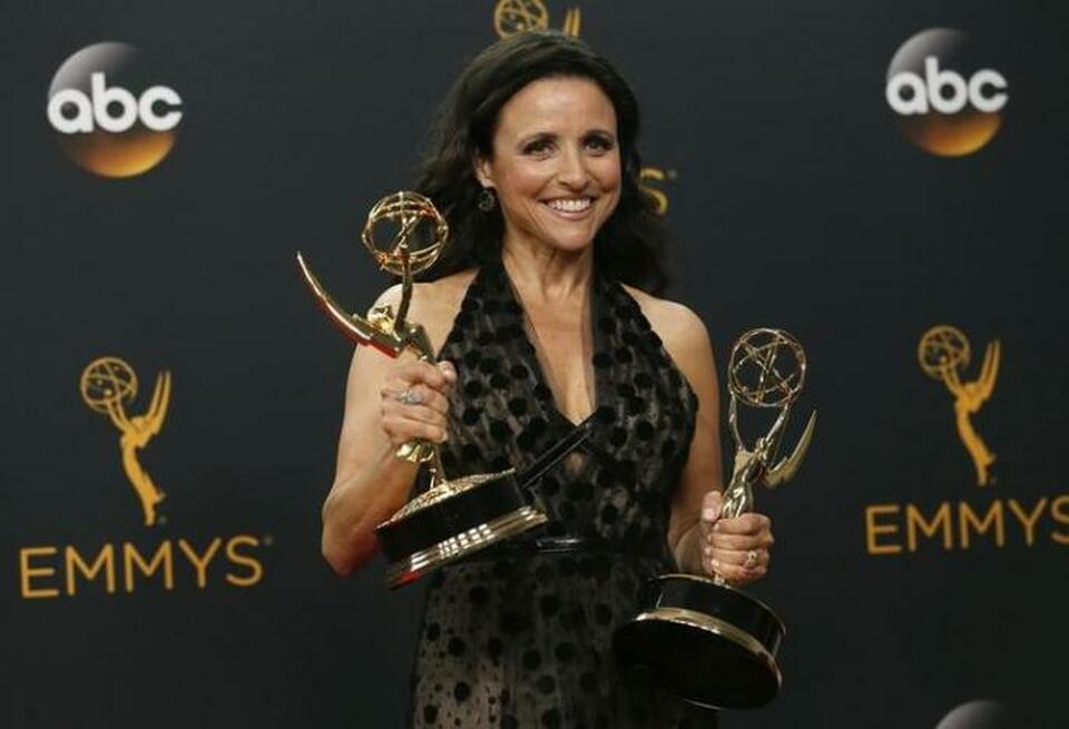 Actress Julia Louis-Dreyfus poses backstage with her awards for Outstanding Comedy Series and Outstanding Lead Actress In A Comedy Series for her role in HBO