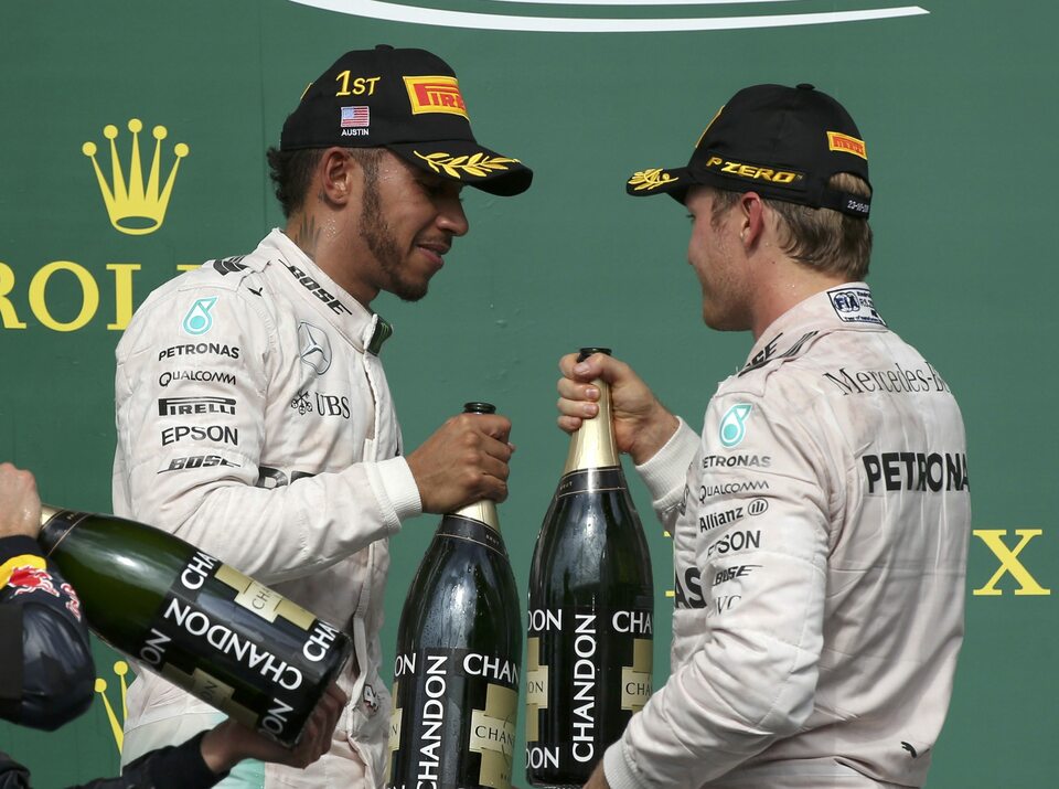 Mercedes's Lewis Hamilton of Britain, left, celebrates his US Grand Prix victory with second-placed finisher and teammate Nico Rosberg of Germany. (Reuters Photo/Adrees Latif)