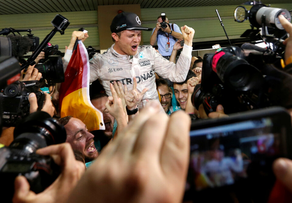 Mercedes' Formula One driver Nico Rosberg of Germany celebrates with his team after winning the Formula One world championship. (Reuters Photo/Ahmed Jadallah)
