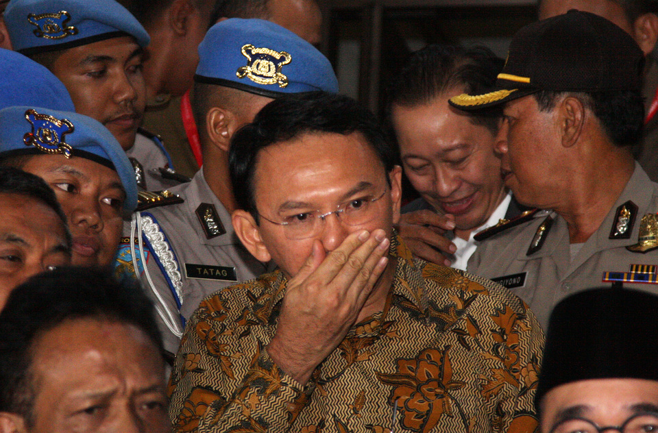 Jakarta governor Basuki 'Ahok' Tjahaja Purnama walks out of police interrogation last year. (Antara Photo/Reno Esnir)