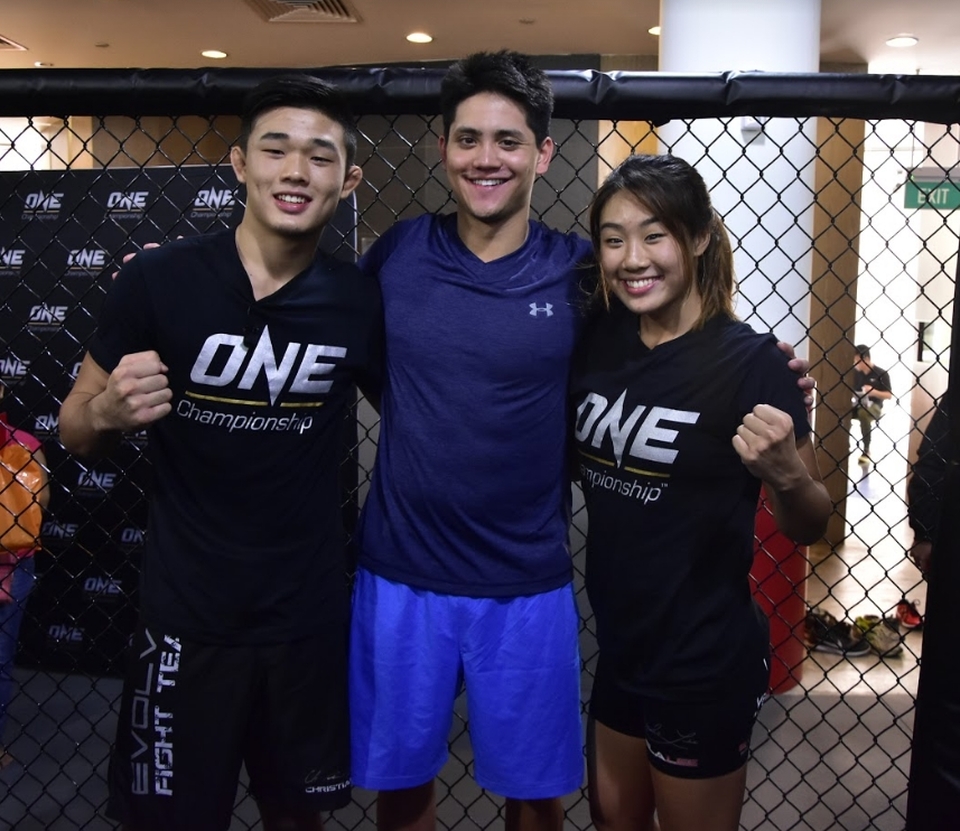 The Singapore's 2016 Olympic gold medalist Joseph Schooling, center, trains with mixed martial artists Christian and Angela Lee. (Photo courtesy of ONE Championship)