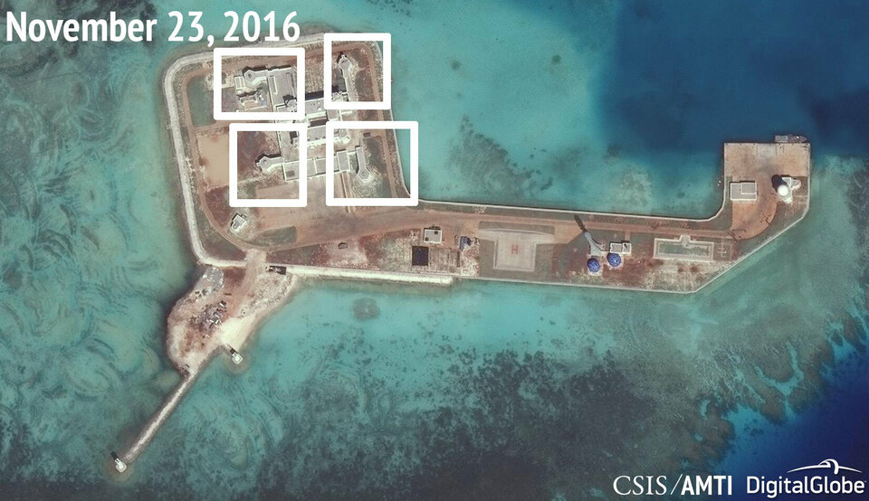 A satellite image shows what CSIS Asia Maritime Transparency Initiative says appears to be anti-aircraft guns and what are likely to be close-in weapons systems (CIWS) on the artificial island Hughes Reef in the South China Sea in this image released on December 13, 2016.   (Reuters Photo/CSIS Asia Maritime Transparency Initiative)