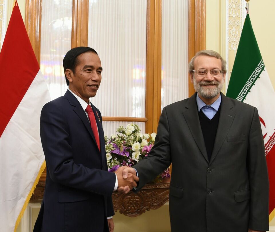 President Joko "Jokowi" Widodo and the current chairman of the Parliament of Iran Ali Larijani shake hands during Jokowi