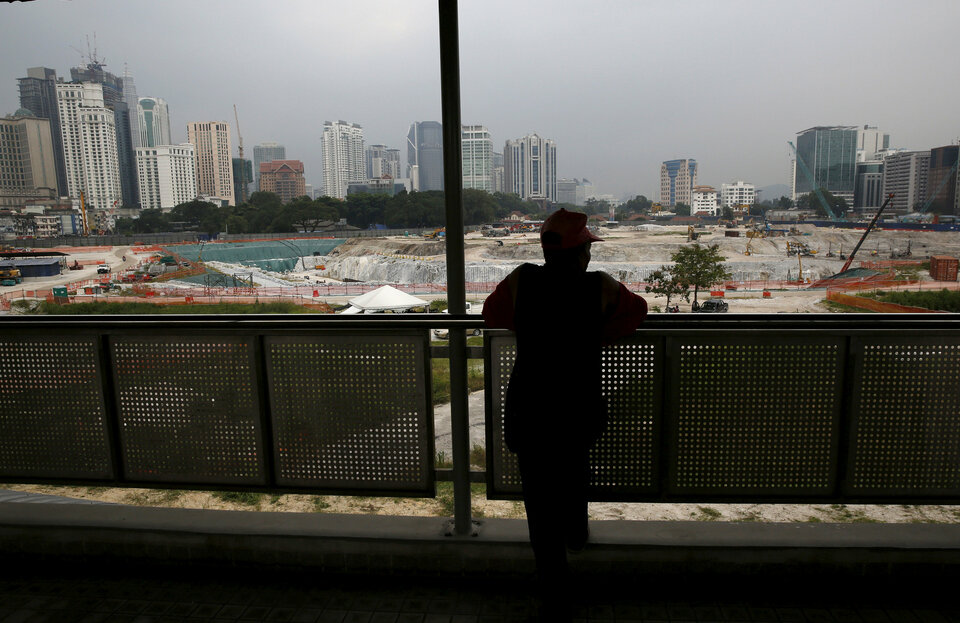 A man looks out at the 1 Malaysia Development Berhad, or 1MDB, flagship Tun Razak Exchange development in Kuala Lumpur. (Reuters Photo/Olivia Harris)