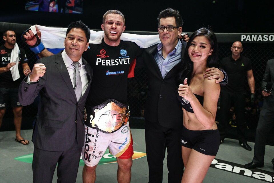 Vitaly Bigdash, center, being crowned ONE middleweight world champion after a fight in 2015. (Photo courtesy of ONE Championship)