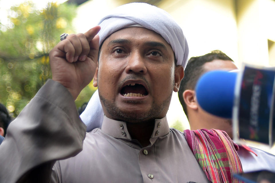 FPI Secretary General Novel Bamukmin at the police headquarters after he filed a police report accusing Ahok of libel and slander, having ridiculed him in public with the 'Fitsa Hats' meme. (Antara Photo/Sigid Kurniawan)