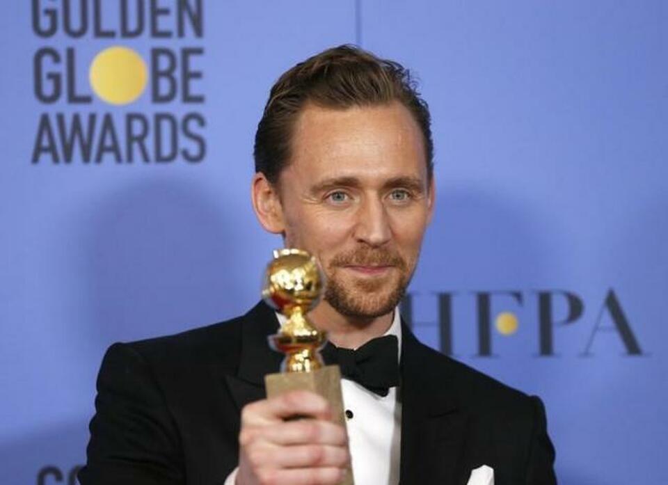 Actor Tom Hiddleston holds the award for Best Performance by an Actor in a Limited Series or a Motion Picture Made for Television for his role in "The Night Manager" during the 74th Annual Golden Globe Awards in Beverly Hills, California, US, January 8, 2017.  (Reuters Photo/Mario Anzuoni)