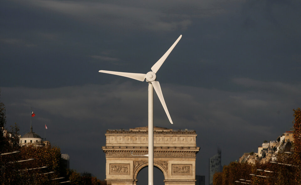 A power-generating windmill turbine is seen in front of the Arc de Triomphe on the Champs Elysees in Paris, ahead of the COP21 World Climate Summit, in this November  2015 file photo. (Reuters Photo/Christian Hartmann)