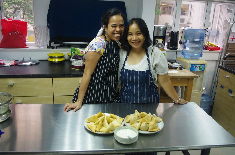 Domestic helpers Elaine, left, and 'Melissa' have learnt to make an Indian dish called samosas at their free cooking training class at the Taste of Hope social enterprise in Hong Kong.  (Reuters Photo)