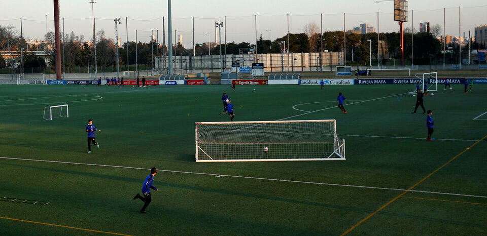 Boys from the RCD Espanyol football academy take part in a training session in Sant Adria de Besos, near Barcelona, Spain, on Feb. 20. (Reuters Photo/Albert Gea)