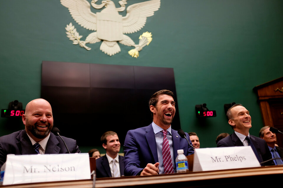 Olympic gold medalist Michael Phelps, center, testifies before a US House of Representatives subcommittee about anti-doping policy in international sport with Olympic gold medalist Adam Nelson, left, and US Anti-Doping Agency chief executive Travis Tygart, right, in Washington, D.C., on Feb. 28. (Reuters Photo/James Lawler Duggan)