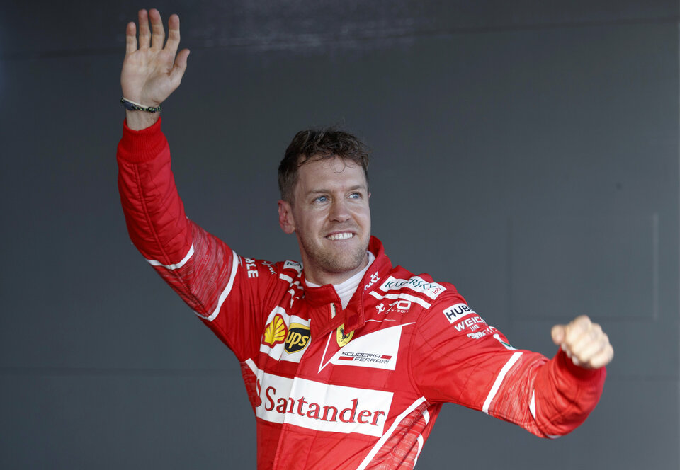 Ferrari driver Sebastian Vettel of Germany reacts in the pits after winning the Australian Formula One Grand Prix on Sunday (26/03). (Reuters Photo/Mark Horsburgh)