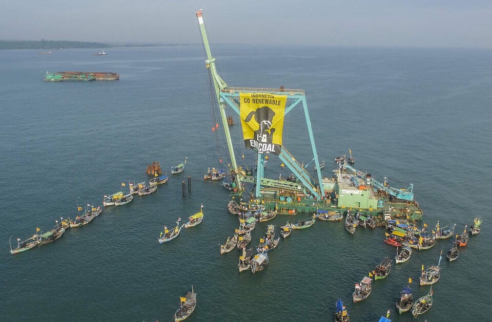 Greenpeace activists and fishermen occupy the piling barges which operates in East Roban waters, Batang, Central Java on March 30, 2017. Those activists from Break Free Coalition, consisting of Greenpeace, WALHI and JATAM unfurl a big banner that calls for a termination to the construction of the coal fired power plant. 
Batang coal power plant is claimed to be the largest in Southeast Asia with a capacity of 2000 megawatts. It will release around 10.8 million tons of carbon into the atmosphere – equals to total carbon emissions of Myanmar in 2009.