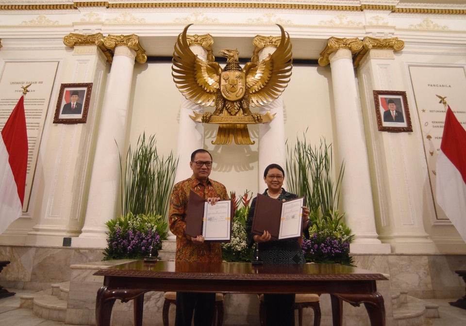 Bank Indonesia Governor Agus Martowardojo, left, and Foreign Minister Retno Marsudi signed off on a partnership to draw more investment into the country in Jakarta on Friday (03/03). (Antara Photo/Akbar Nugroho Gumay)