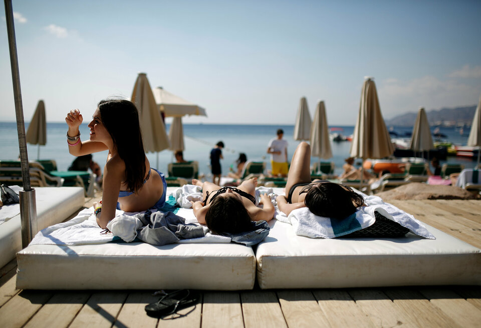 Tourists sunbathe on a beach in the Red Sea resort city of Eilat, one of Israel's most popular holiday spots, in this  February 2014 file photo. (Reuters Photo/Amir Cohen)