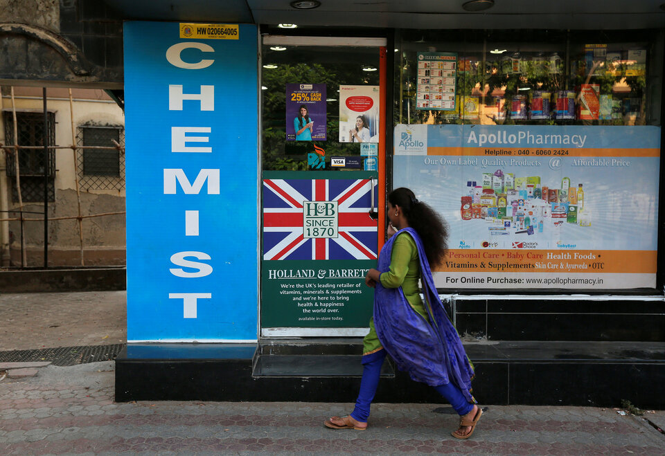 A woman walks past a chemist shop in Mumbai on Friday (28/04). (Reuters Photo/Shailesh Andrade)