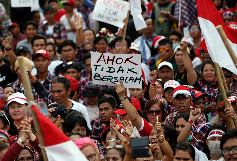 Supporters of Jakarta Governor Basuki Tjahaja Purnama, popularly called Ahok, stage a protest outside Cipinang Prison, where he was taken following his conviction for blasphemy in Jakarta on May 9. The sign reads 'Ahok is not guilty.' (Reuters Photo/Darren Whiteside)
