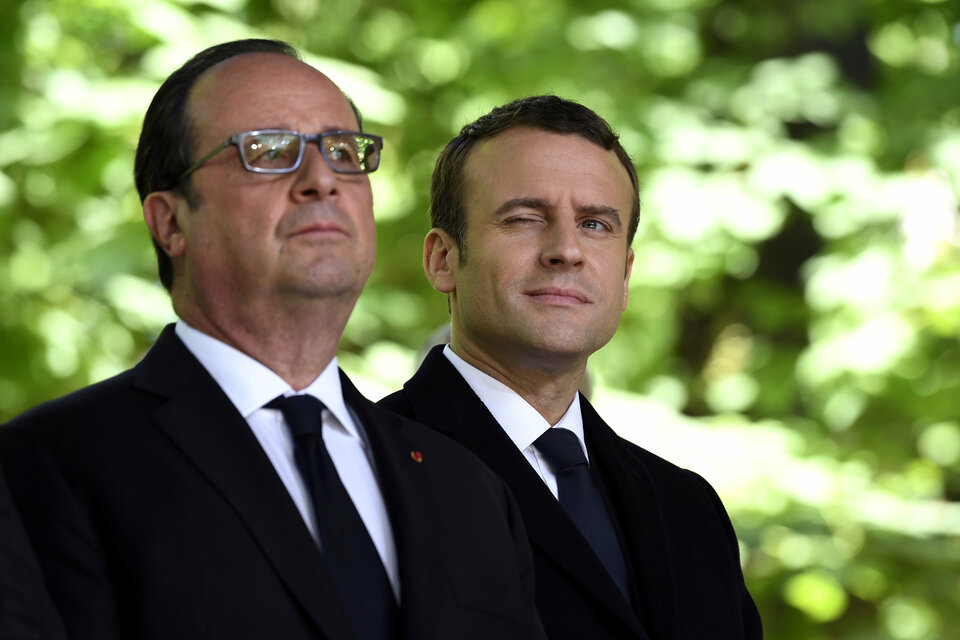 Outgoing French President Francois Hollande, left, and President-Elect Emmanuel Macron attend a ceremony to mark the anniversary of the abolition of slavery and to pay tribute to the victims of the slave trade at the Jardins du Luxembourg in Paris, France, on May 10. (Reuters Photo/Eric Feferberg)