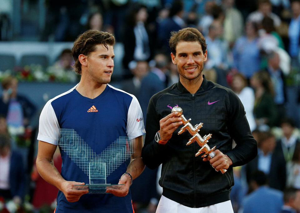 Rafael Nadal, right, and Dominic Thiem pose with their Madrid Open trophies. (Reuters Photo/Susana Vera)