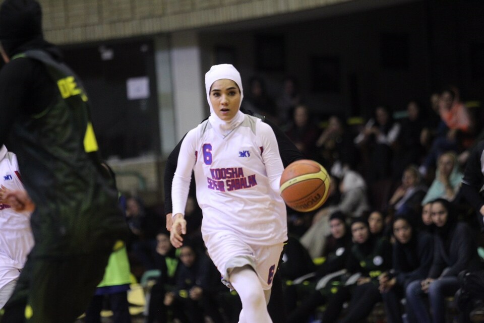 A female basketball player wearing a hijab during a match in Iran. (Photo courtesy of FIBA's official website)
