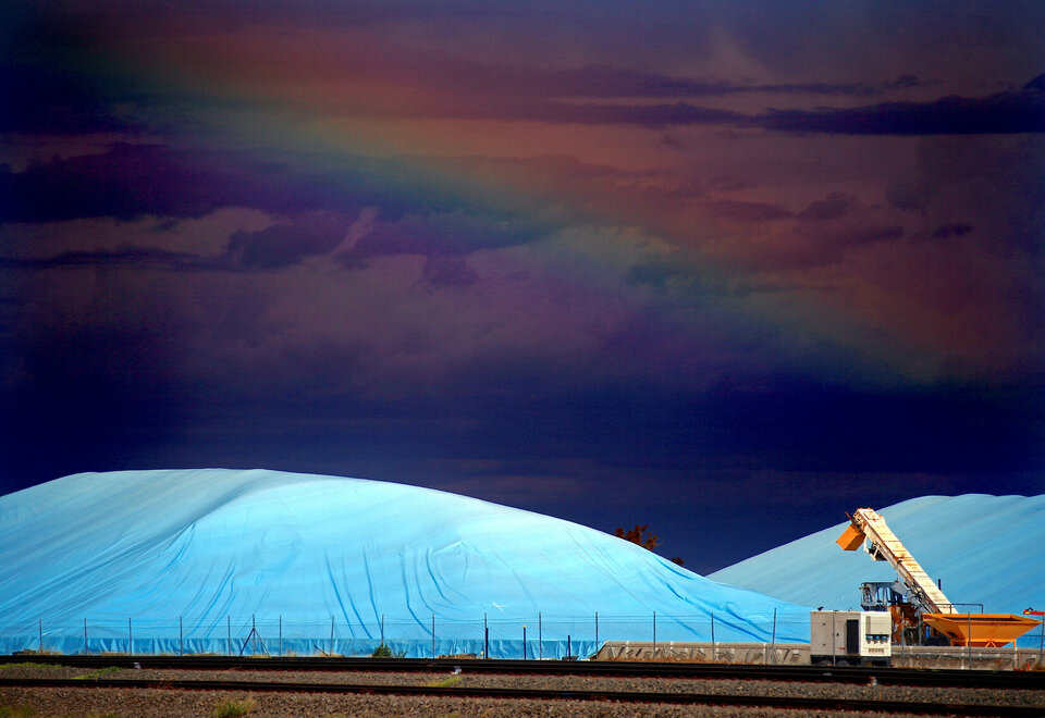 Piles of harvested wheat are covered with plastic sheets near the depot for GrainCorp, Australia's largest listed bulk grain handler, located in the New South Wales town of Burren Junction, north-west of Sydney, on March 15, 2017.  (Reuters Photo/David Gray)                    
