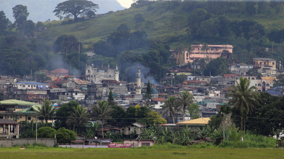 Smoke comes from a burning building as government troops continue their assault against insurgents from the Maute group, who have taken over large parts of Marawi City in the southern Philippines on June 15. (Reuters Photo/Romeo Ranoco)