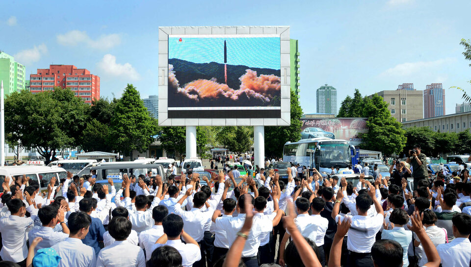 People watch a huge screen showing the test launch of intercontinental ballistic missile Hwasong-14 in this undated photo released by North Korea's Korean Central News Agency (KCNA), July 5. (Reuters Photo/KCNA)