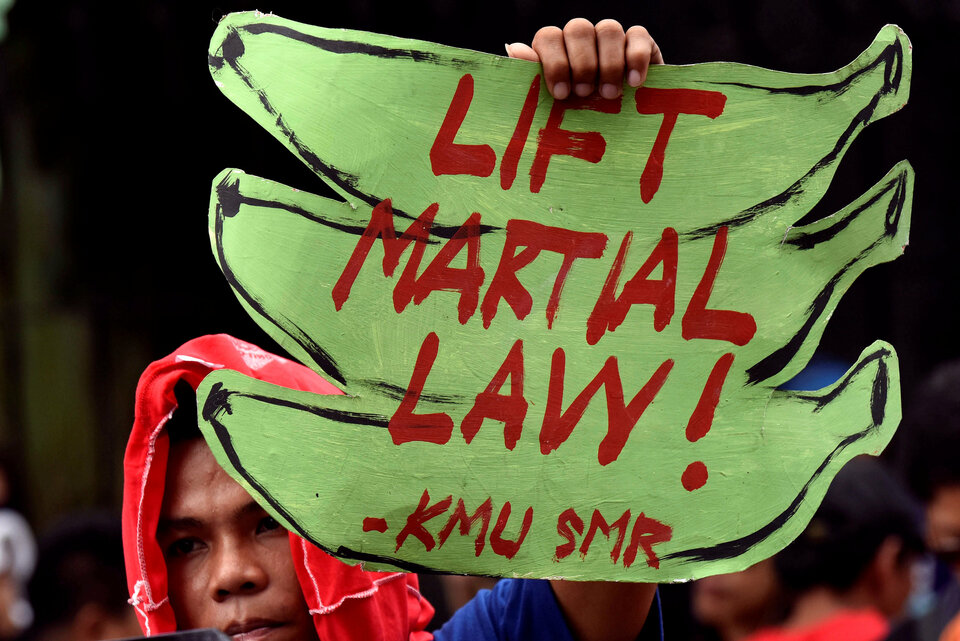 An anti martial law protestor hold a placard while protesting during the special session on the extension of martial law  at the House of Representatives in Quezon City, metro Manila, Philippines July 22, 2017. REUTERS/Dondi Tawatao)
