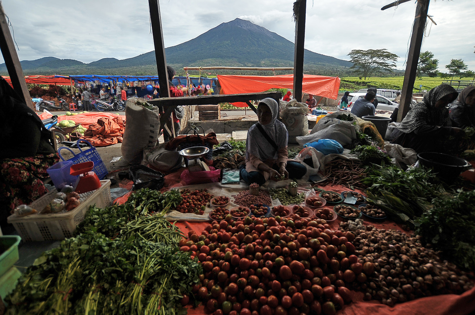 Sellers wait for customers in a traditional market at the foot of Mount Kerinci in Jambi on the island of Sumatra on Friday (30/06). (Antara Photo/Wahdi Septiawan)