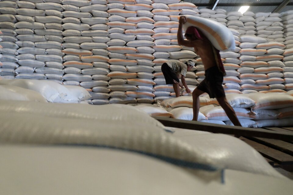 FILE - A worker carries a sack of rice at a Bulog warehouse in Medan, North Sumatra. (Antara Photo)