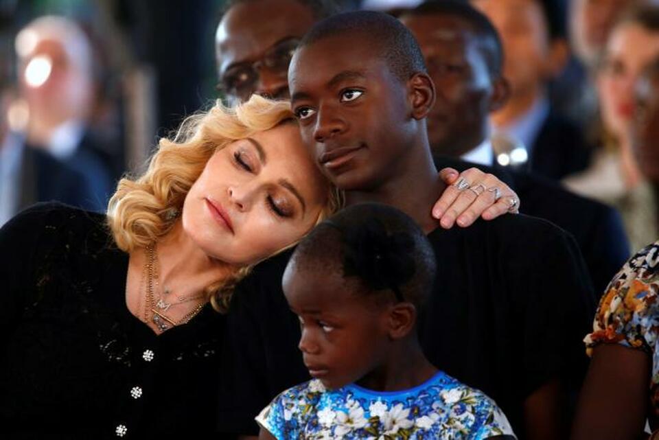 US singer Madonna embraces her adopted son, David Banda ahead of the opening of the Mercy James hospital in Blantyre, Malawi, July 11,2017. (Reuters Photo/Siphiwe Sibeko)