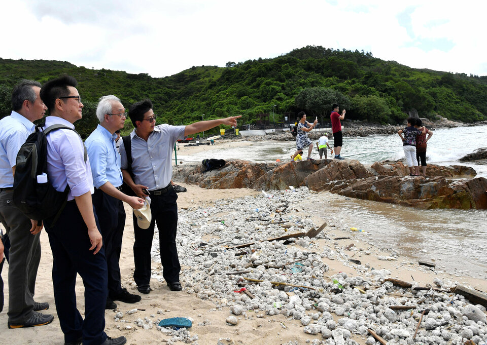 Under Secretary for the Environment Tse Chin-wan visits a beach at Lamma Island on the progress of the cleaning up of palm oil by the government, in Hong Kong, China, Aug. 8.  (Reuters Photo/Hong Kong Information Services Department)