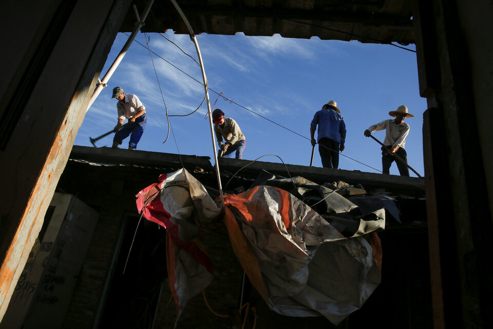 Workers prepare concrete roof slabs for their removal from former migrant dwellings before their destruction at Dongsanqi village in the outskirts of Beijing, Aug. 7. (Reuters Photo/Thomas Peter)