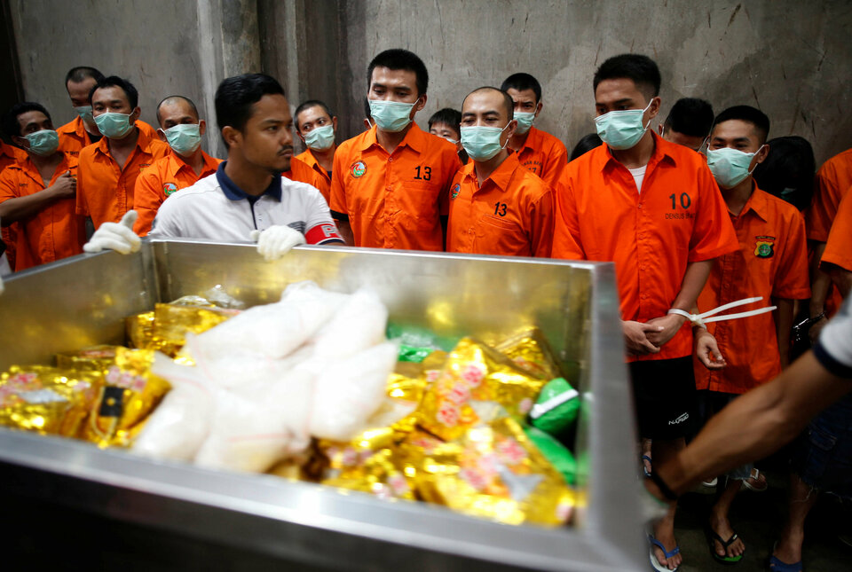 Drug suspects watch as recently confiscated narcotics, including 1.4 tonnes methamphetamine and a large amount of ecstasy pills, are wheeled to an incinerator by police following a ceremony by drug enforcement agencies in Jakarta, Indonesia August 15, 2017. (Reuters Photo/Darren Whiteside)