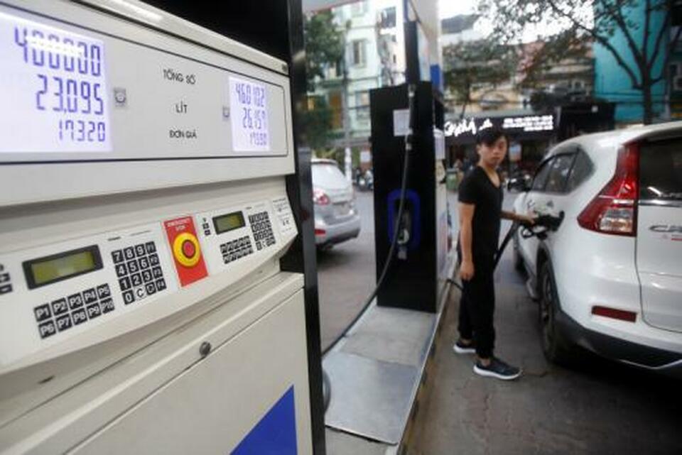 A man pumps petrol for his car at a petrol station in Hanoi. (Reuters Photo
