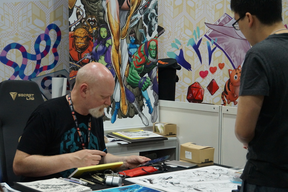 Legendary comic book artist Arthur Adams doing commission work for a fan at the SIngapore Toy, Game and Comic Convention at the Sands Expo and Convention Center over the weekend. (JG Photo/Dhania Sarahtika)