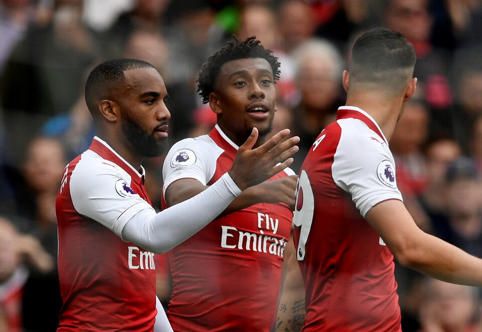 Arsenal's Alex Iwobi celebrates scoring their second goal with Alexandre Lacazette and Granit Xhaka. (Reuters Photo/Tony O'Brien)