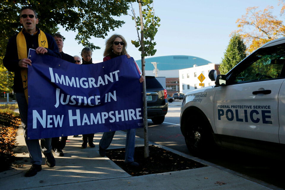 Demonstrators hold an 'interfaith prayer vigil for immigrant justice' outside the federal building in Manchester, New Hampshire, where ethnic Chinese Christians who fled Indonesia after widescale rioting decades ago and overstayed their visas in the United States, must check in with immigration officials. (Reuters Photo/Brian Snyder)