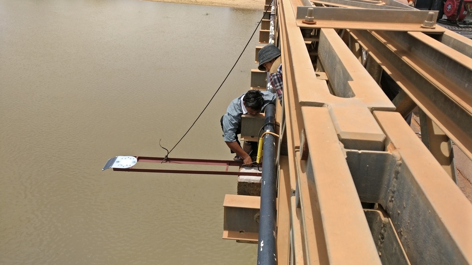 An automated water gauge to help predict floods is fixed to a bridge over a river in Cambodia. (Reuters Photo)