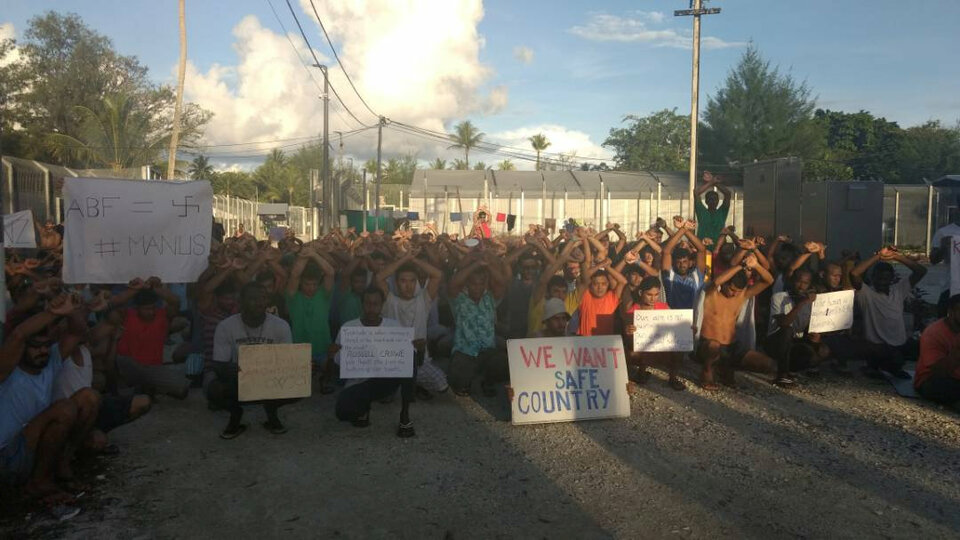 Asylum seekers hold placards in protest to moving to another center on Manus island, Papua New Guinea, November 13, 2017.  (Reuters Photo/Social Media)