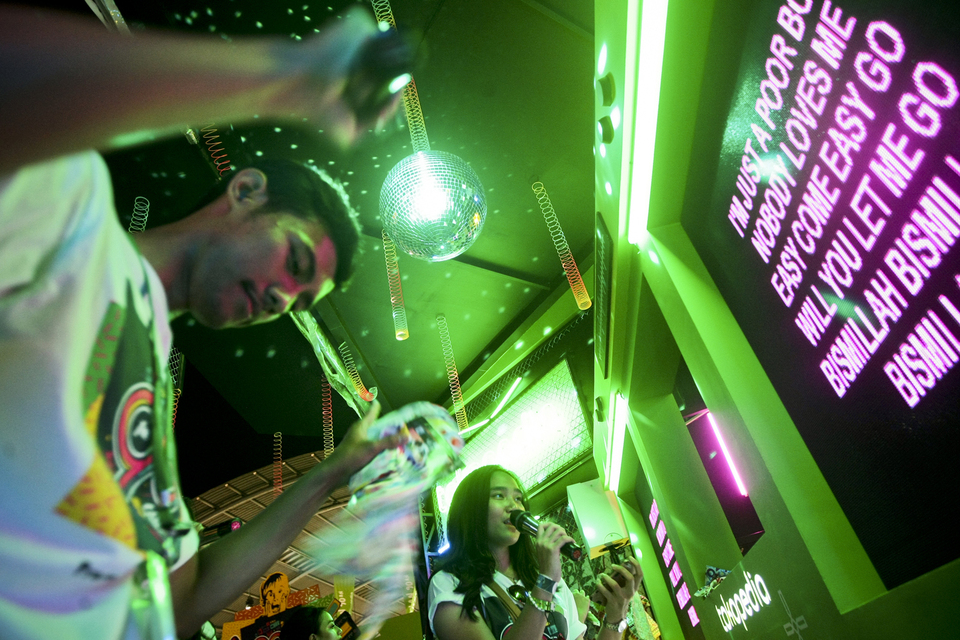 Karaoke visitors singing Queen songs at a karaoke house.