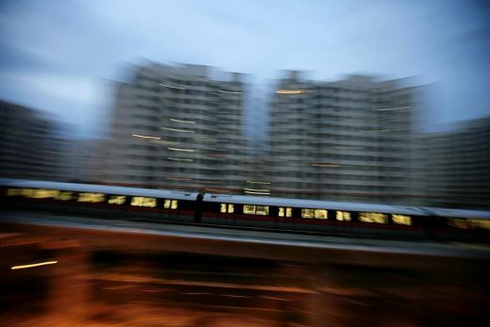 An MRT train travels along a track in a neighborhood in Singapore February 28, 2010. (Reuters Photo/Pablo Sanchez)