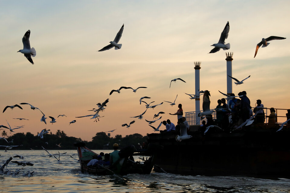 Seagulls fly over a jetty on the banks of the Yangon River in Yangon, Myanmar, on Nov. 30. (Reuters Photo/Jorge Silva)