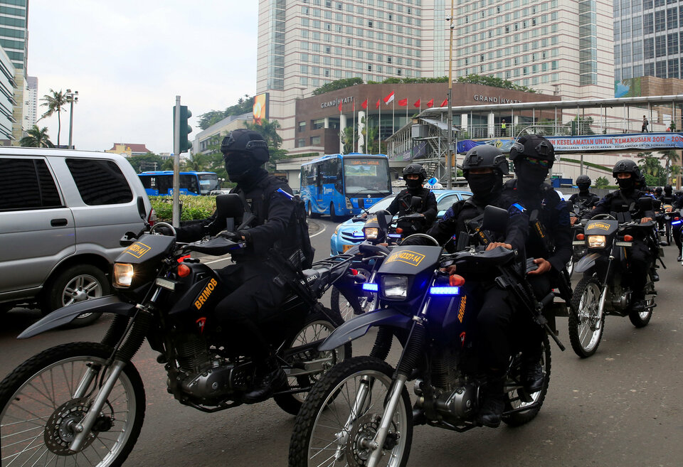 Police officers patrol Jakarta during the Christmas holidays. (Reuters Photo/Beawiharta)