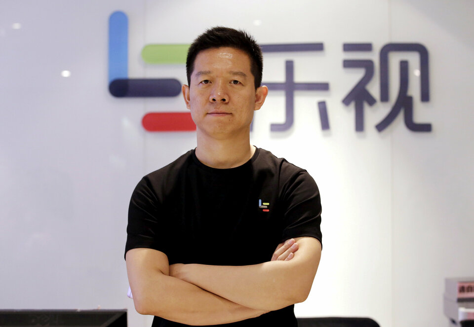 Jia Yueting, co-founder and head of Le Holdings Co Ltd, also known as LeEco and formerly as LeTV, poses for a photo in front of a logo of his company after a Reuters interview at LeEco headquarters in Beijing, China April 22, 2016.  (Reuters Photo/Jason Lee)
