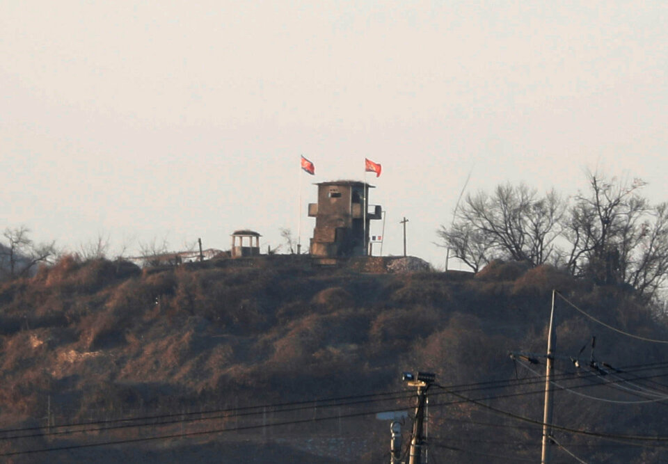 A North Korean flag flutters on the top of their guard post inside North Korean territory in this picture taken near the demilitarized zone separating the two Koreas in Paju, South Korea, January 3, 2018.  (Reuters Photo/Kim Hong-Ji)
